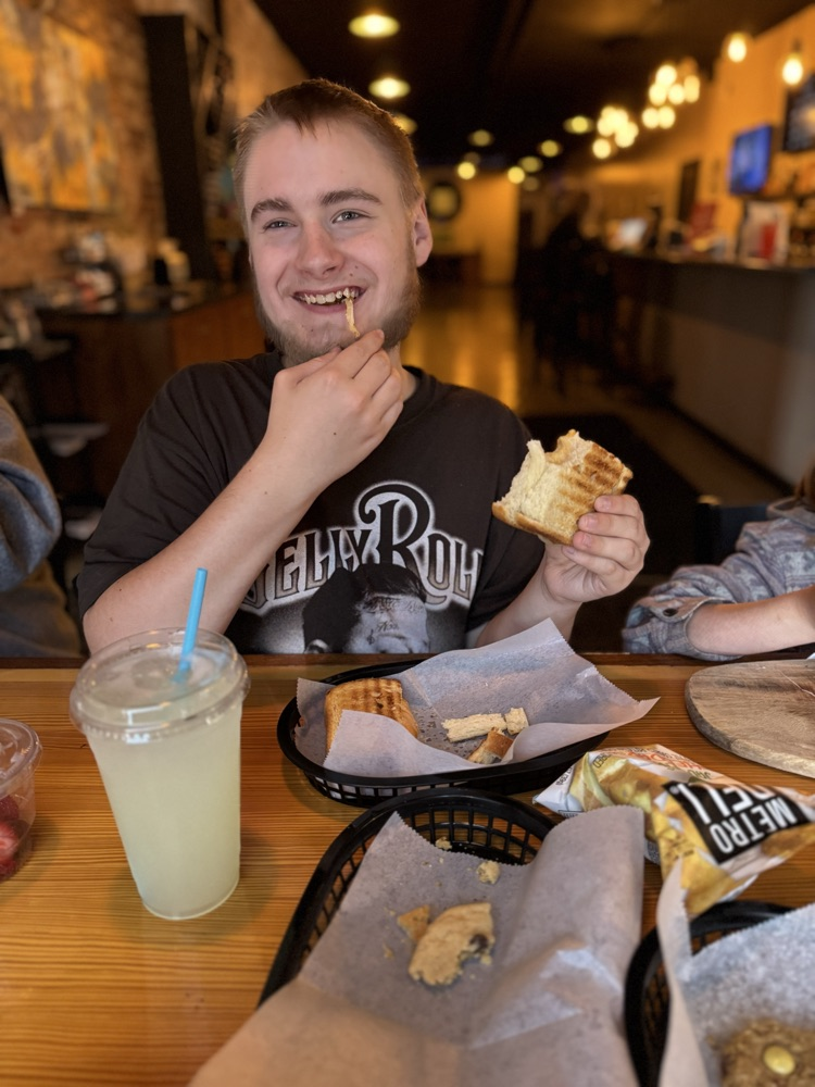 student eating grilled cheese 