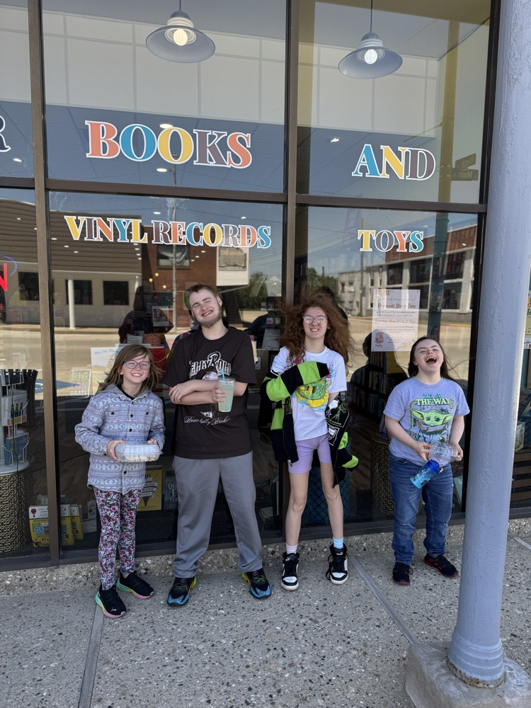 four students in front of bookstore 