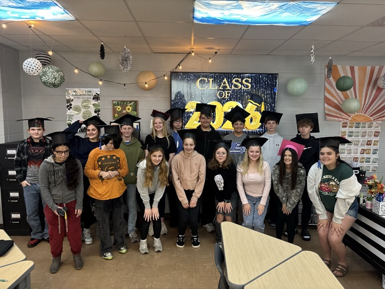 Students smiling in mortarboards  