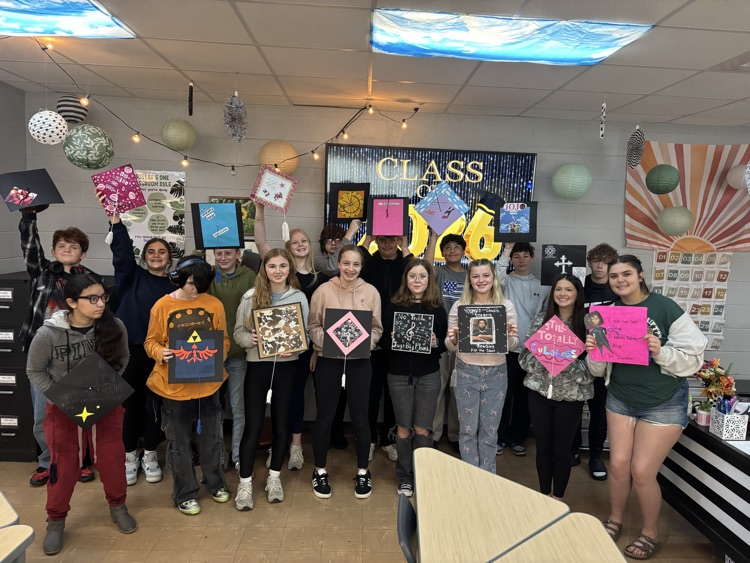 Students smiling with mortarboards  