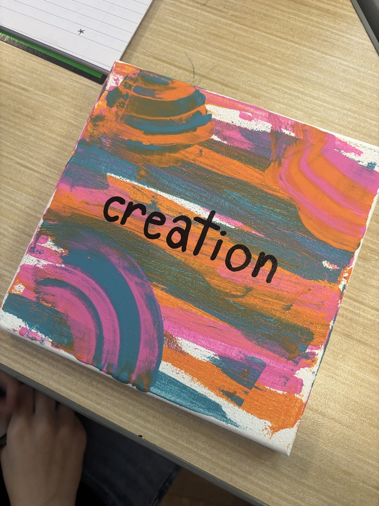 canvas with “creation” painted on it