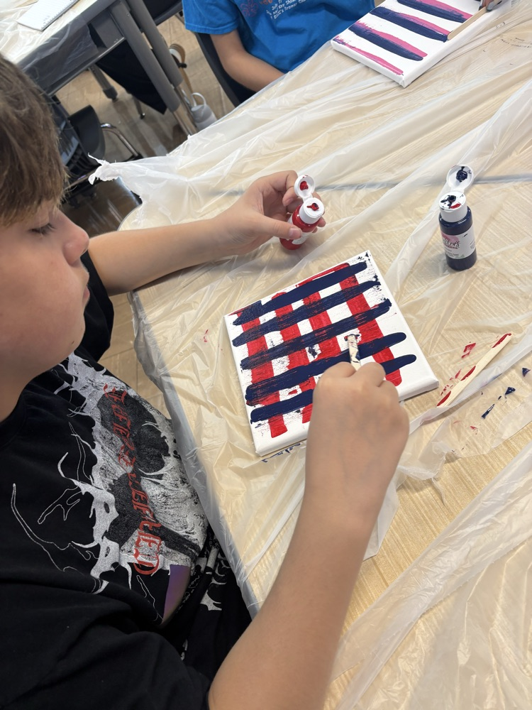 student painting canvas