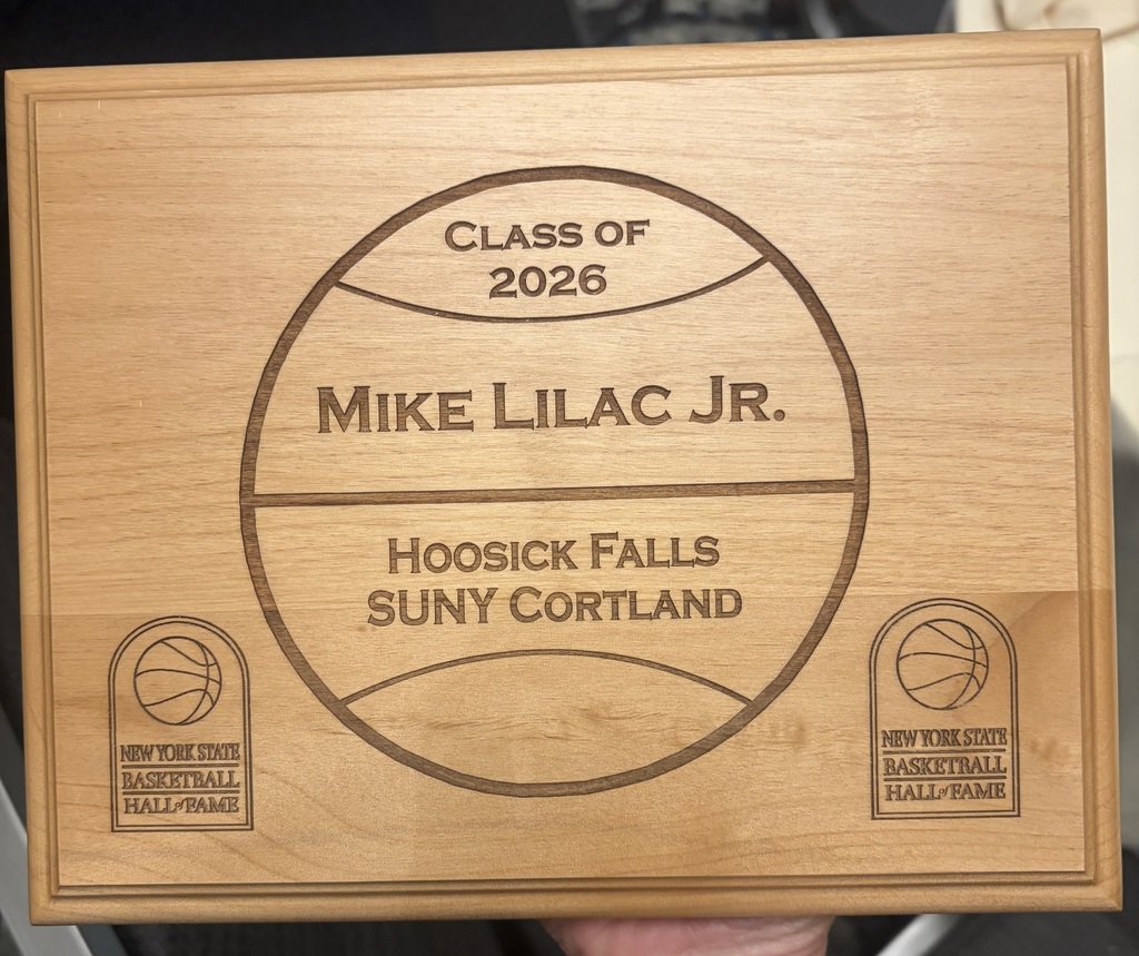 On Sunday, April 19, 2026, the New York State Basketball Hall of Fame inducted its Class of 2026 at a ceremony held at the Hilton Garden Inn in Troy, NY. Among the distinguished honorees was Coach Mike Lilac Jr., longtime Varsity Basketball and Baseball Coach at Hoosick Falls.  Coach Lilac joins an elite class of NYS basketball inductees, including three-time NBA champion and NCAA champion, Danny Green and Yale University's all-time winningest coach, James Jones. Coach Lilac was introduced by Rodger Wyland, News Channel 13's Sports Director and host of Big Board Sports. Some of Coach Lilac's accomplishments include being the Wasaren Leagues All-time winningest Basketball Coach with 462 wins, and over 400 wins for Varsity Baseball.