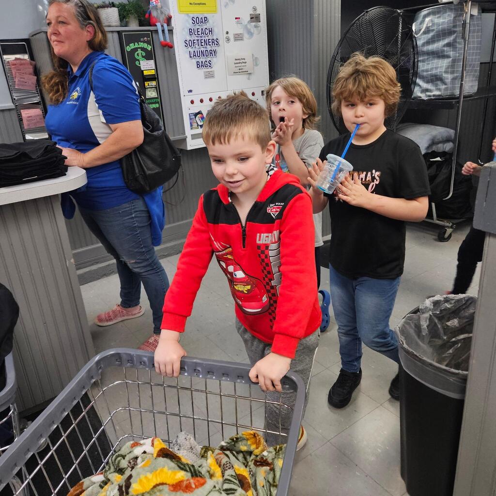 Elementary teacher Mrs. Cross has another “community integration field trip” to share! These trips allow students to explore some of the community helper roles they have been learning about in the classroom. Students visited the laundry mat in the Village! The kiddos made change, put coins into the washer, poured detergent, and watched the laundry spin! They walked to the store and purchased a drink, and then returned when the wash was done and put the blankets into the dryer. They did a great job, and they had an awesome time out in the community! Thanks for sharing, Mrs. Cross! 