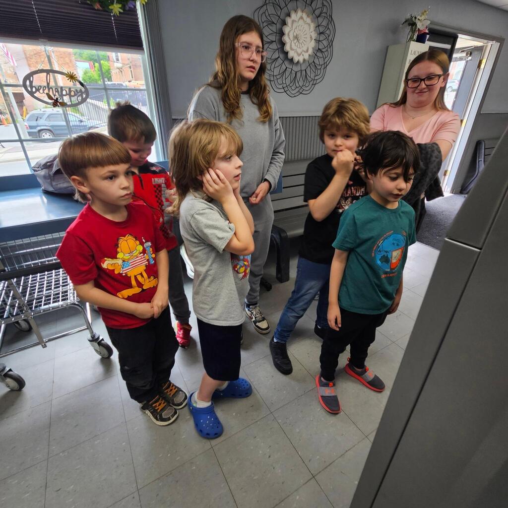 Elementary teacher Mrs. Cross has another “community integration field trip” to share! These trips allow students to explore some of the community helper roles they have been learning about in the classroom. Students visited the laundry mat in the Village! The kiddos made change, put coins into the washer, poured detergent, and watched the laundry spin! They walked to the store and purchased a drink, and then returned when the wash was done and put the blankets into the dryer. They did a great job, and they had an awesome time out in the community! Thanks for sharing, Mrs. Cross! 