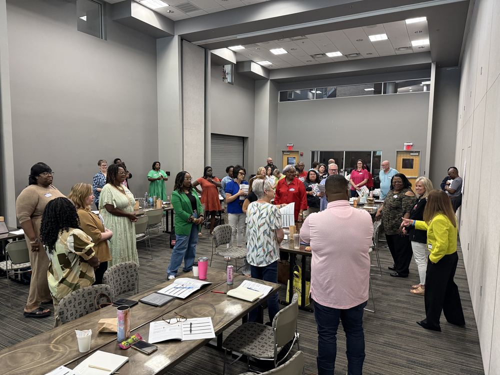 Large Room full of poeple standing 