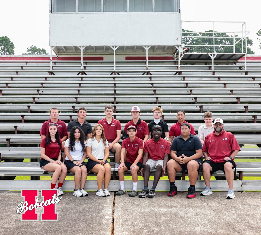Group photo of the 2026–2027 Hope High School Golf team and coach posed together on stadium bleachers.