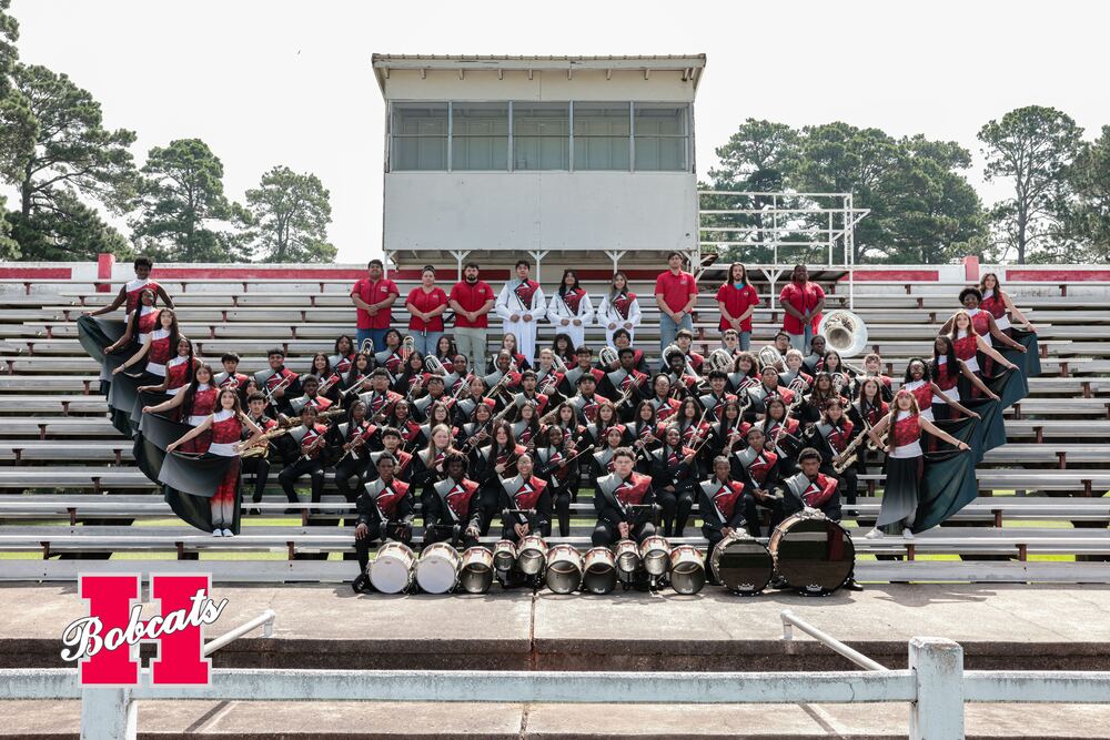 Group photo of the 2026–2027 Hope High School Band on stadium bleachers, including student musicians, percussion, drum majors, color guard members, and band staff.