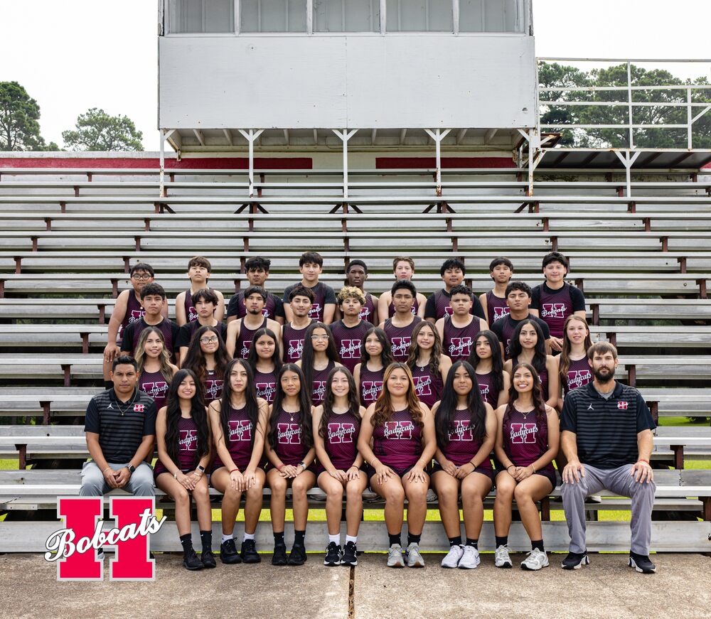 Group photo of the 2026–2027 Hope High School Cross Country team and coaches seated and standing together on stadium bleachers.