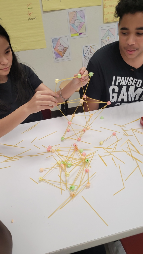 a marshmallow and pasta Tower with marshmallow and pasta scattered below it