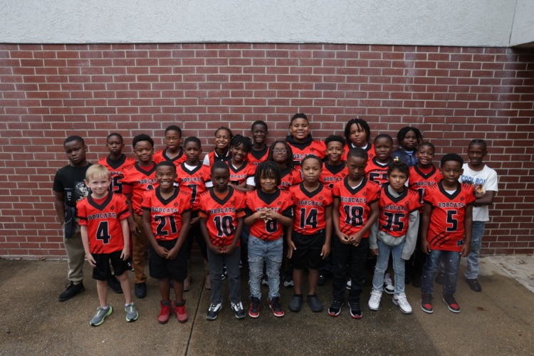 Photos of the Little League Wildcats football team and cheerleaders getting ready for their first game of the season.