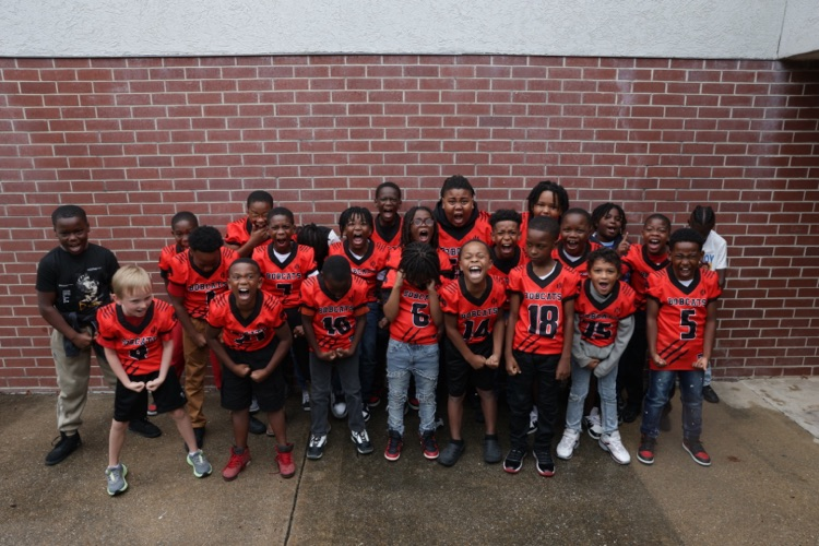 Photos of the Little League Wildcats football team and cheerleaders getting ready for their first game of the season.