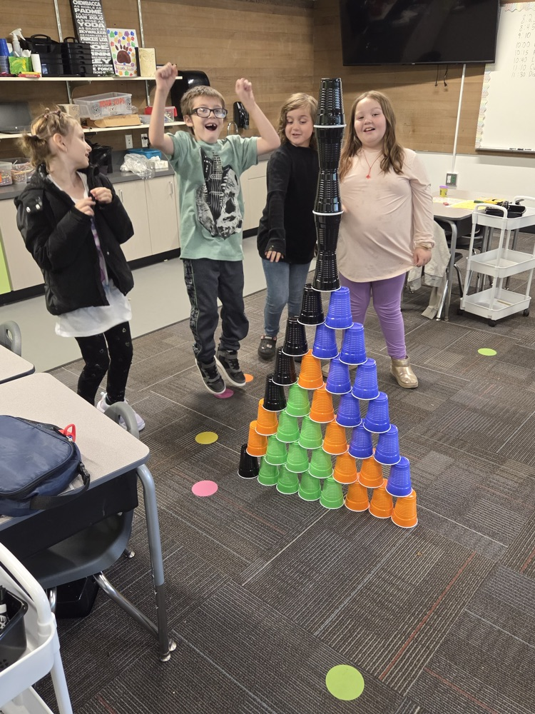 students making a tower with cups