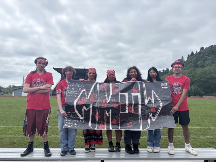 students holding MWIW banner