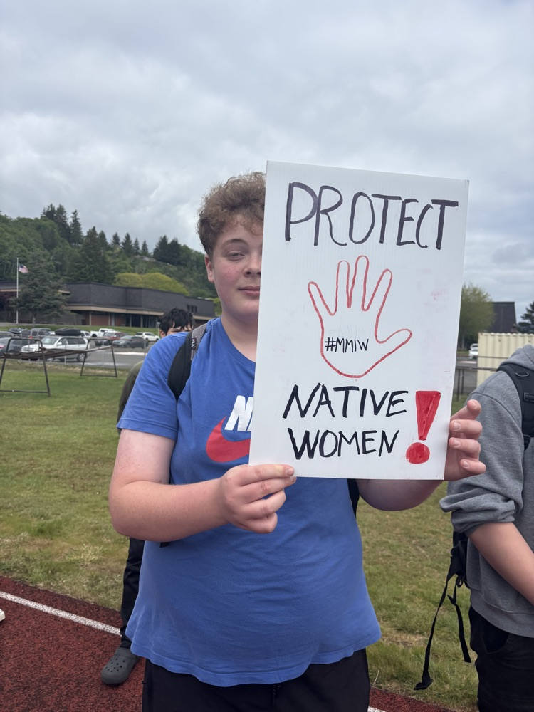 student holding sign saying “protect native women"