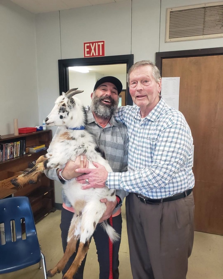 Mr Dawson pictured with a fellow staff member and a goat!