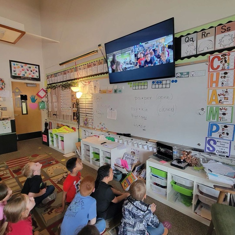 students looking at and hearing about pictures shown on tv