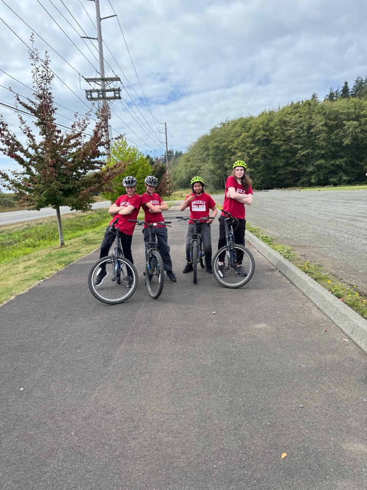 four students on bikes