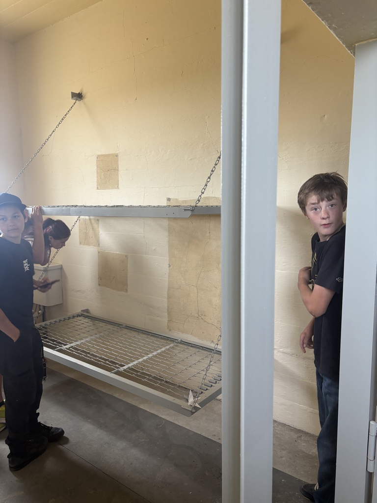 Students looking around in the jail. 