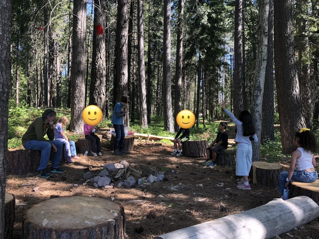 Group of students with the science teacher on the woods.