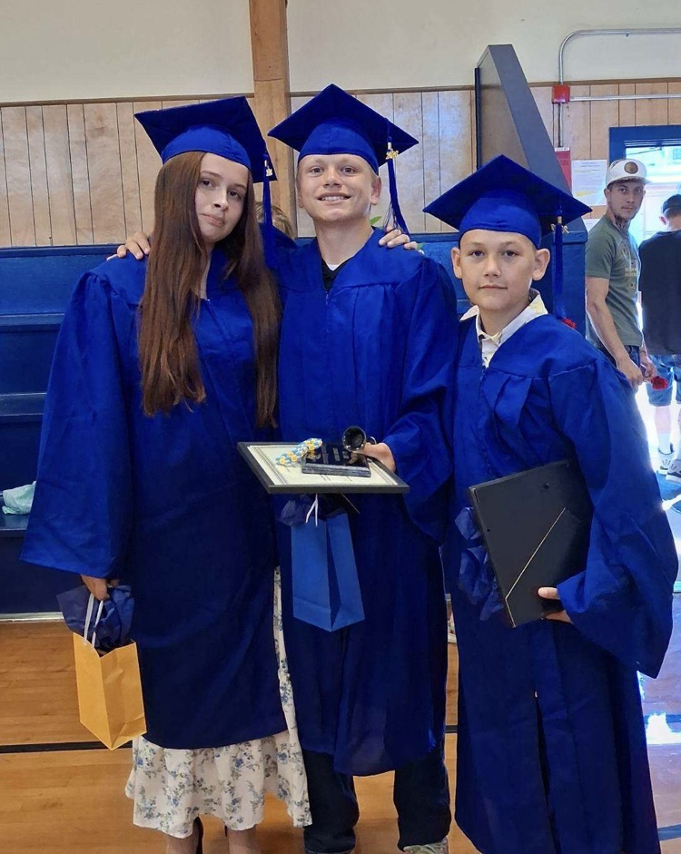 Three students in their graduation gowns