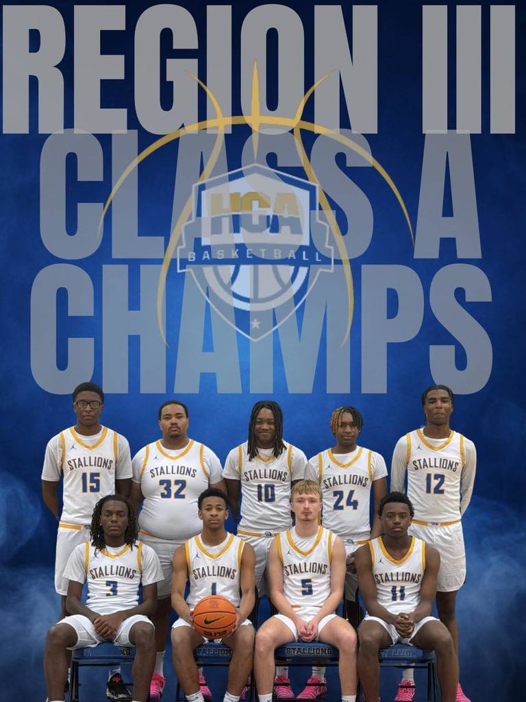 A basketball team poses for a photo in front of a blue backdrop with text. Eleven players in white jerseys.