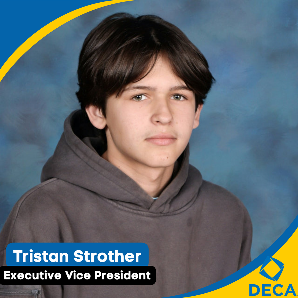 A young person with short hair, wearing a gray hoodie, looks forward against a blue backdrop.