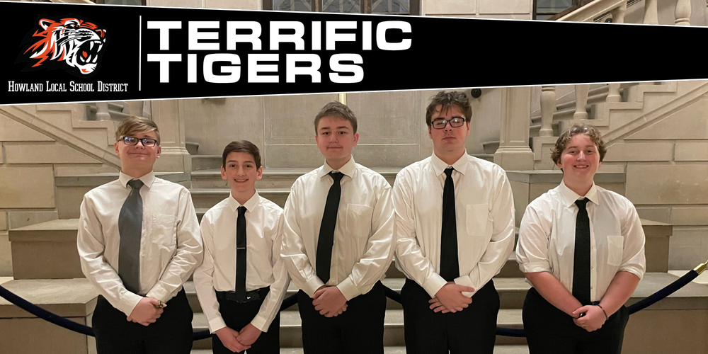Five Howland band students stand together holding their instruments after performing in the Stambaugh Youth Concert Band spring concert.