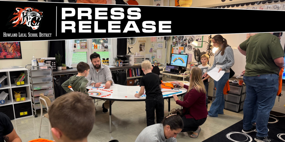 Kindergarten students and their families participate in hands-on literacy activities during Fall Family Literacy Night at Howland Springs Primary School.