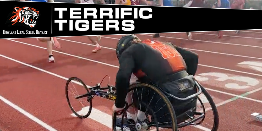 Kellan Shipman races in a wheelchair track event, pushing powerfully down the track during competition.