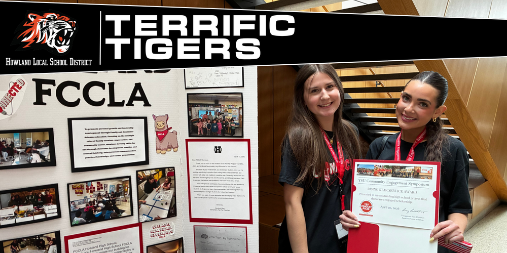 Two students holding an award at the YSU Community Engagement Symposium