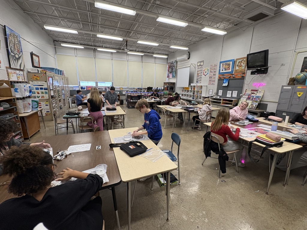 Eighth graders creating cultural paper-mâché masks