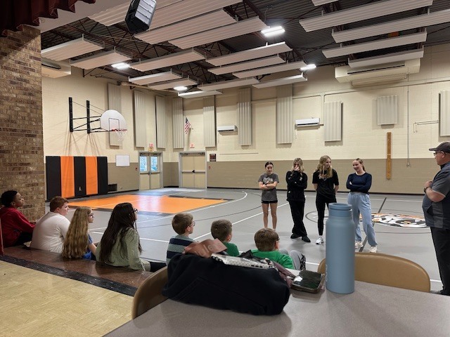 Students running with cross country team