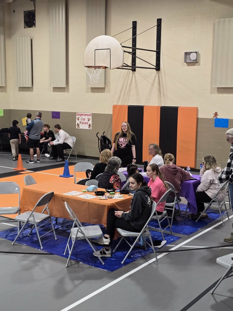 Candy Land-themed literacy night with students and families participating in reading activities, colorful game stations, and candy-inspired decorations throughout the school.