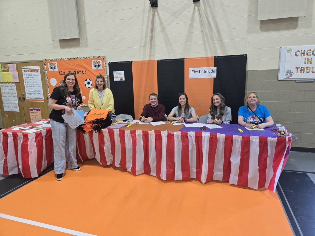 Candy Land-themed literacy night with students and families participating in reading activities, colorful game stations, and candy-inspired decorations throughout the school.