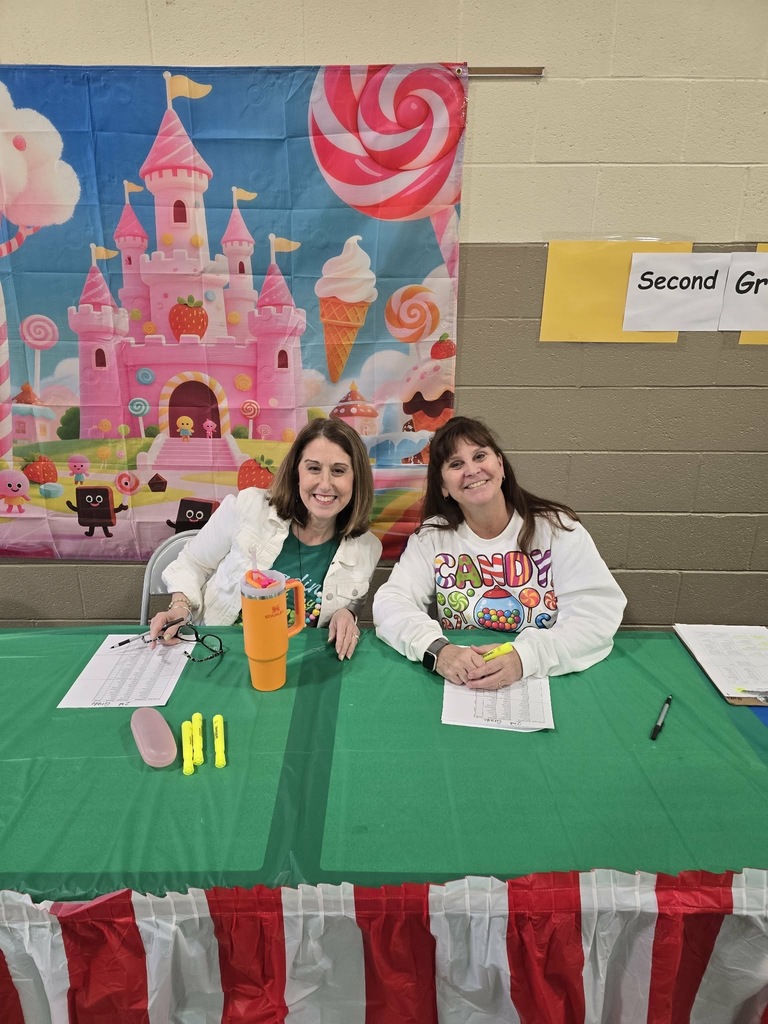 Candy Land-themed literacy night with students and families participating in reading activities, colorful game stations, and candy-inspired decorations throughout the school.