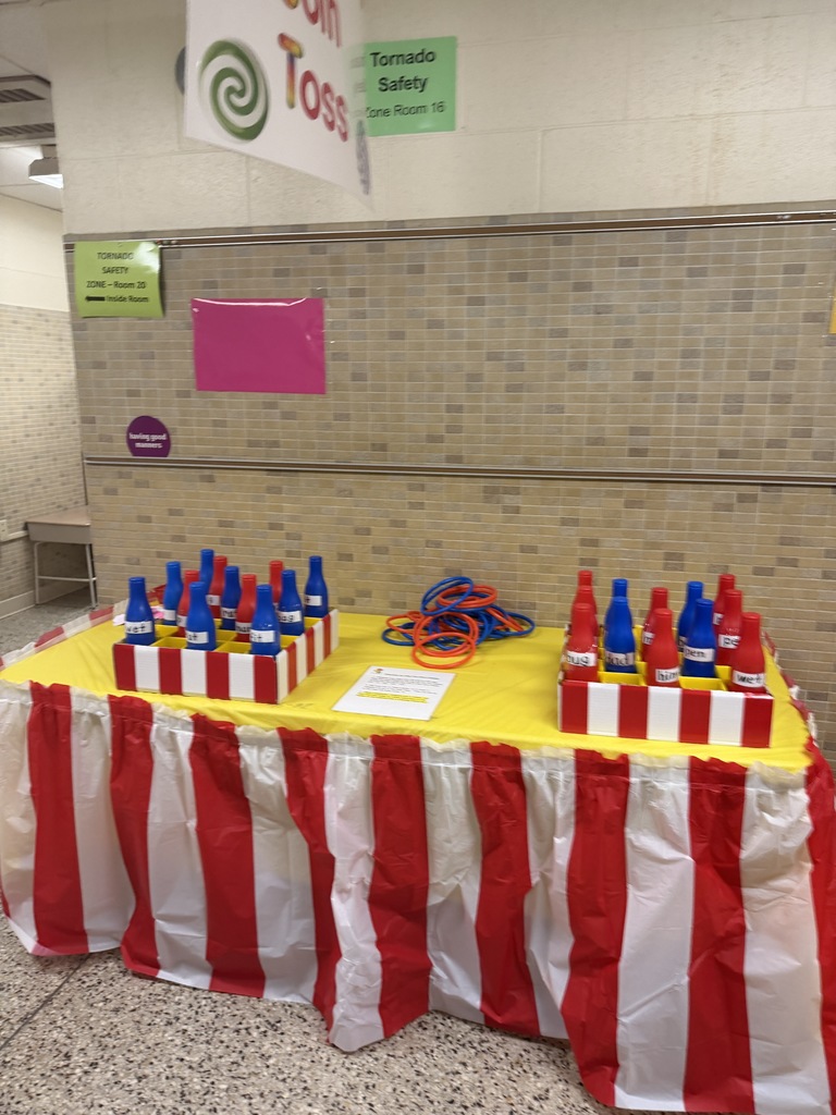 Candy Land-themed literacy night with students and families participating in reading activities, colorful game stations, and candy-inspired decorations throughout the school.