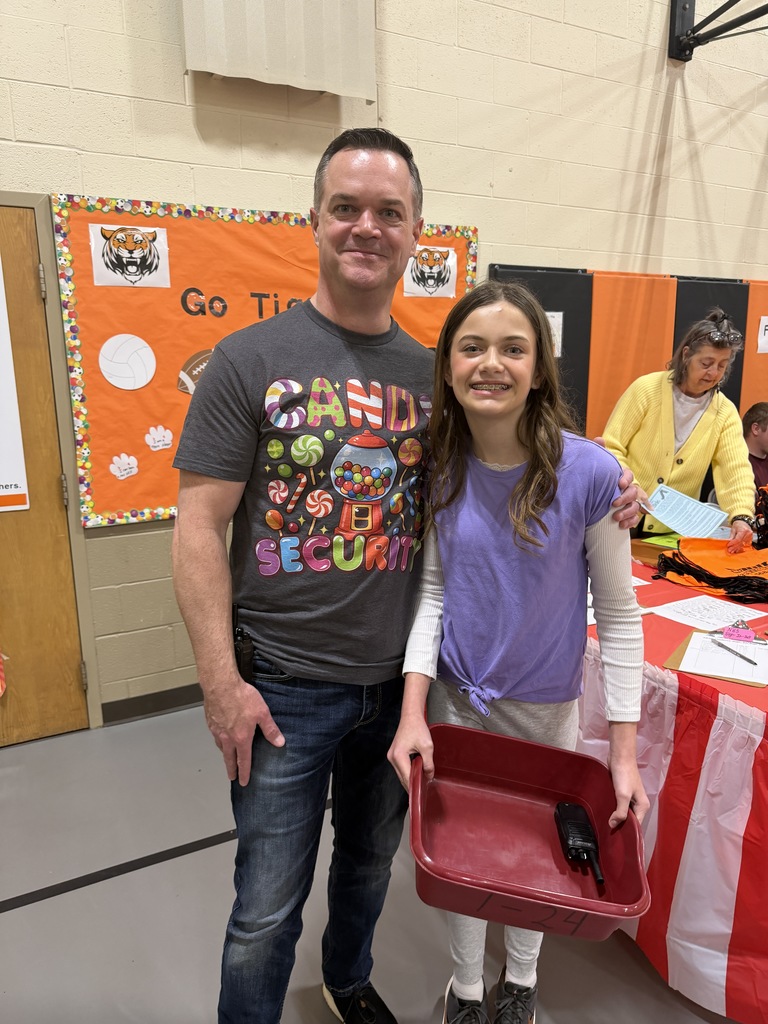 Candy Land-themed literacy night with students and families participating in reading activities, colorful game stations, and candy-inspired decorations throughout the school.