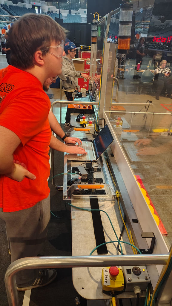 Robotics team working on a robot during a competition.
