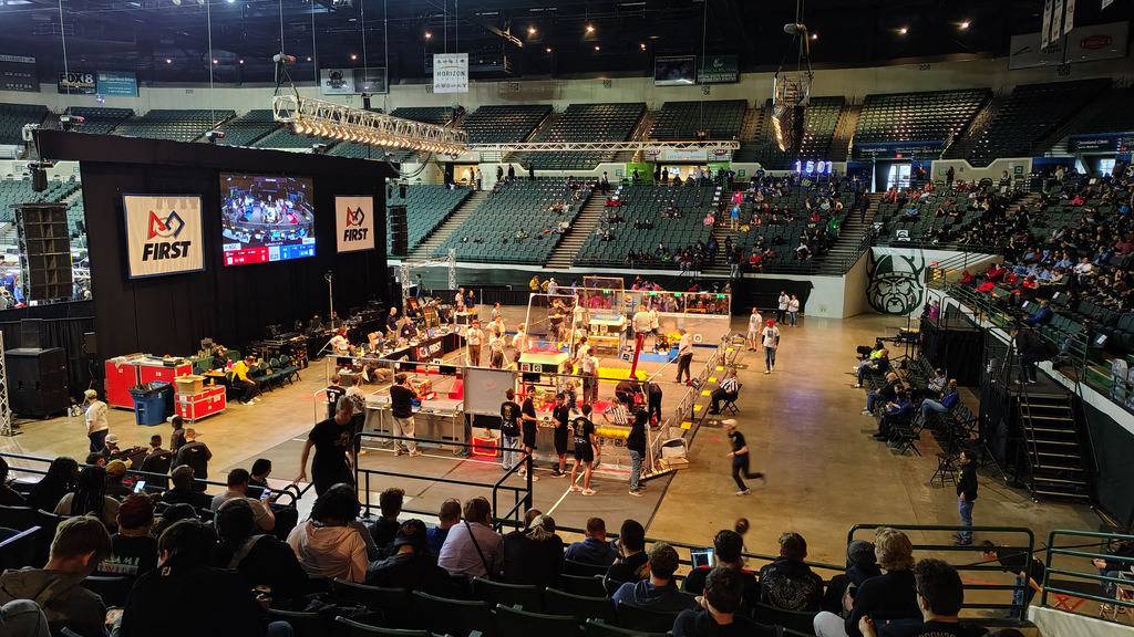 Robotics team working on a robot during a competition.
