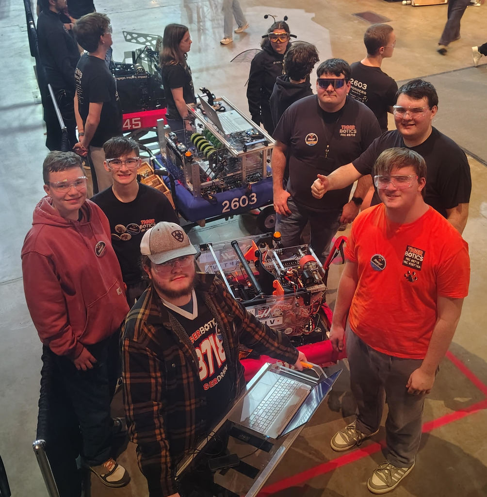 Robotics team working on a robot during a competition.