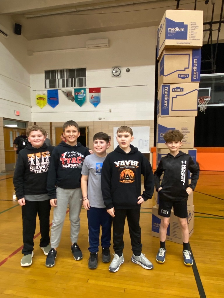 Students cheering and participating in games during a school pep assembly