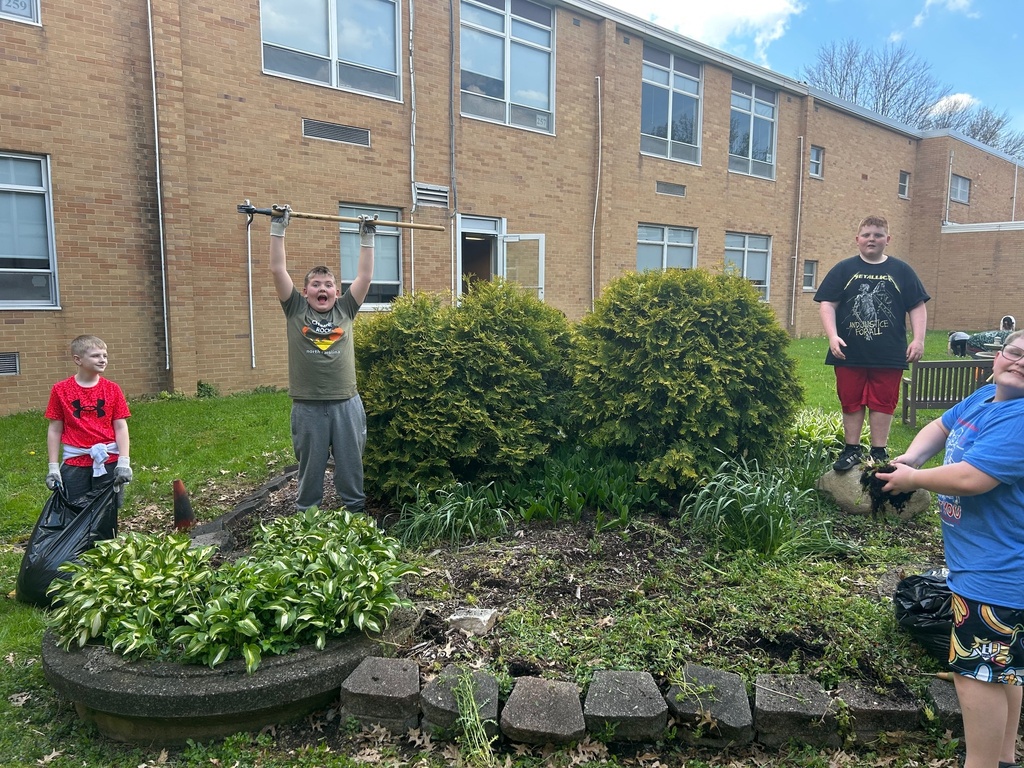 Students from Howland Intermediate School’s Science Club work together in the courtyard at Howland Middle School as part of an Earth Day beautification project.