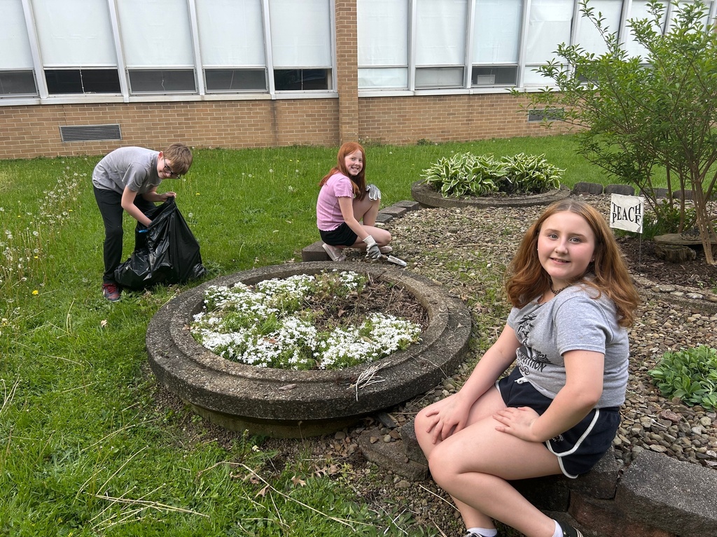 Students from Howland Intermediate School’s Science Club work together in the courtyard at Howland Middle School as part of an Earth Day beautification project.