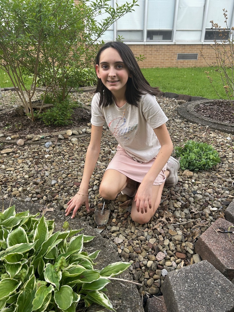 Students from Howland Intermediate School’s Science Club work together in the courtyard at Howland Middle School as part of an Earth Day beautification project.