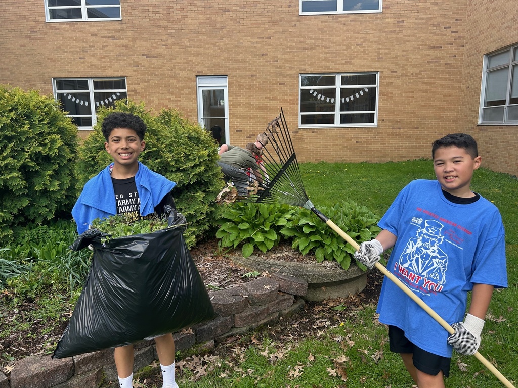 Students from Howland Intermediate School’s Science Club work together in the courtyard at Howland Middle School as part of an Earth Day beautification project.