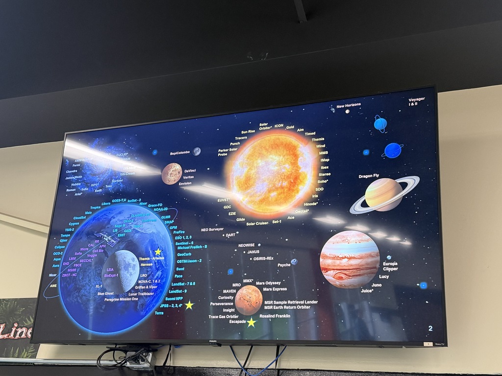 Space-themed graphic announcing a NASA presentation for Howland Junior High students featuring NASA engineer Patrick Barnes