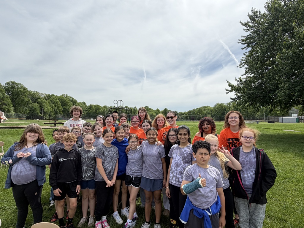 Howland High School seniors in orange shirts volunteer throughout the community during Senior Day of Service, helping at schools, parks, and local organizations.