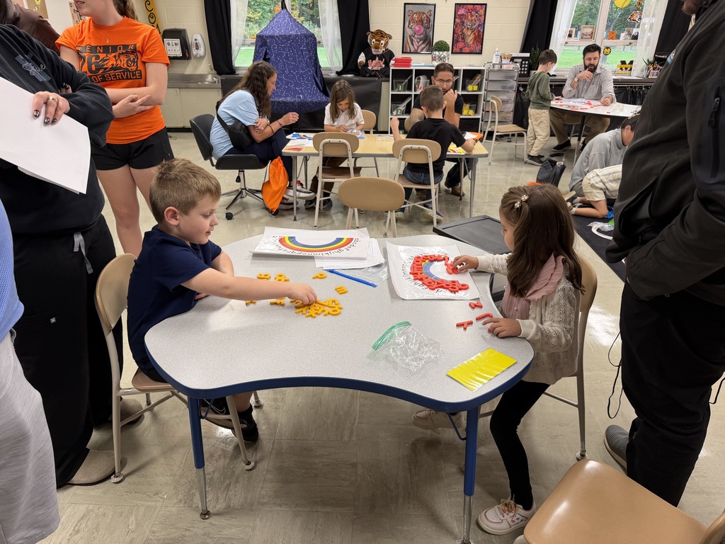 Kindergarten students and their families participate in hands-on literacy activities during Fall Family Literacy Night at Howland Springs Primary School.