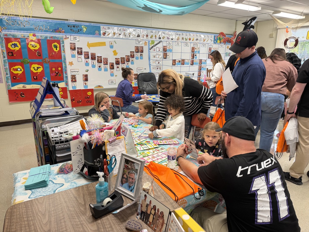 Kindergarten students and their families participate in hands-on literacy activities during Fall Family Literacy Night at Howland Springs Primary School.